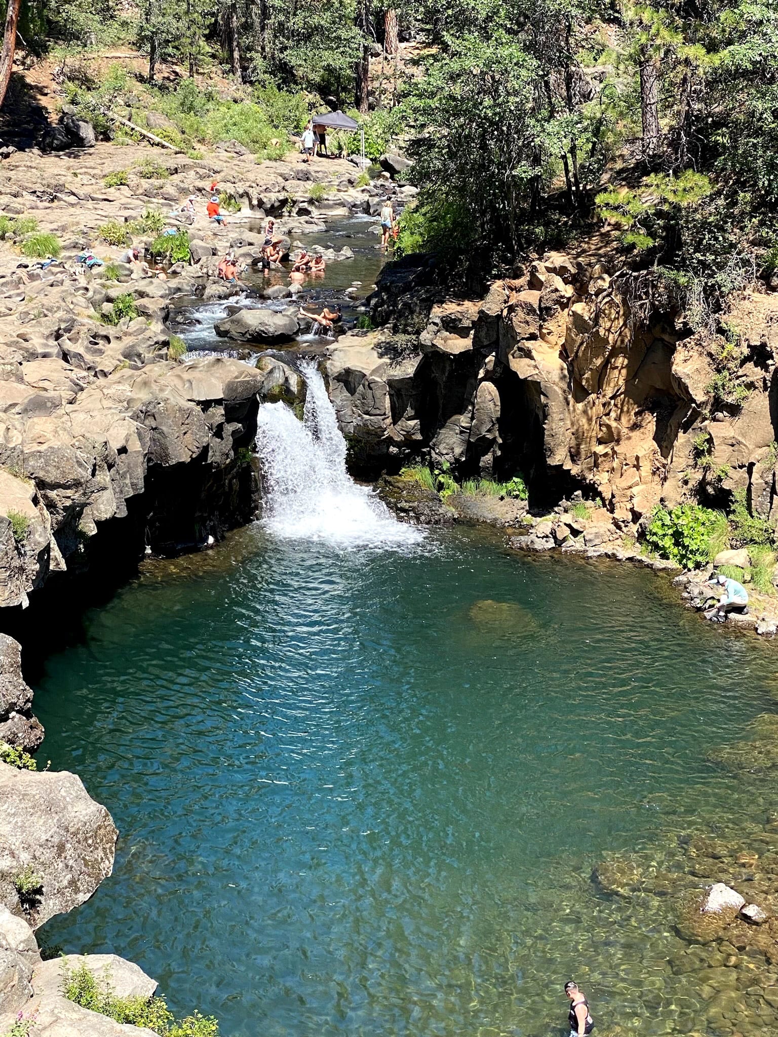 Sacred waterfall swimming hole in forest