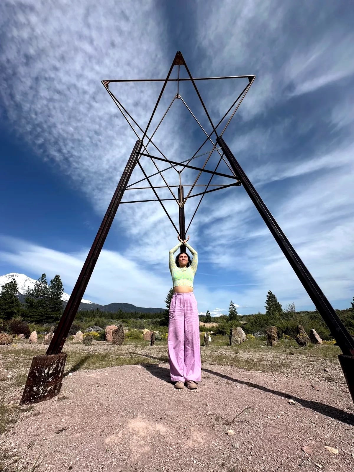Woman with star sculpture outdoors